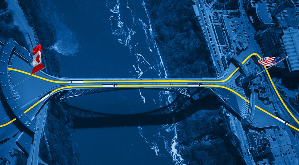 Overview perspective of Canada-U.S. bridge above river 