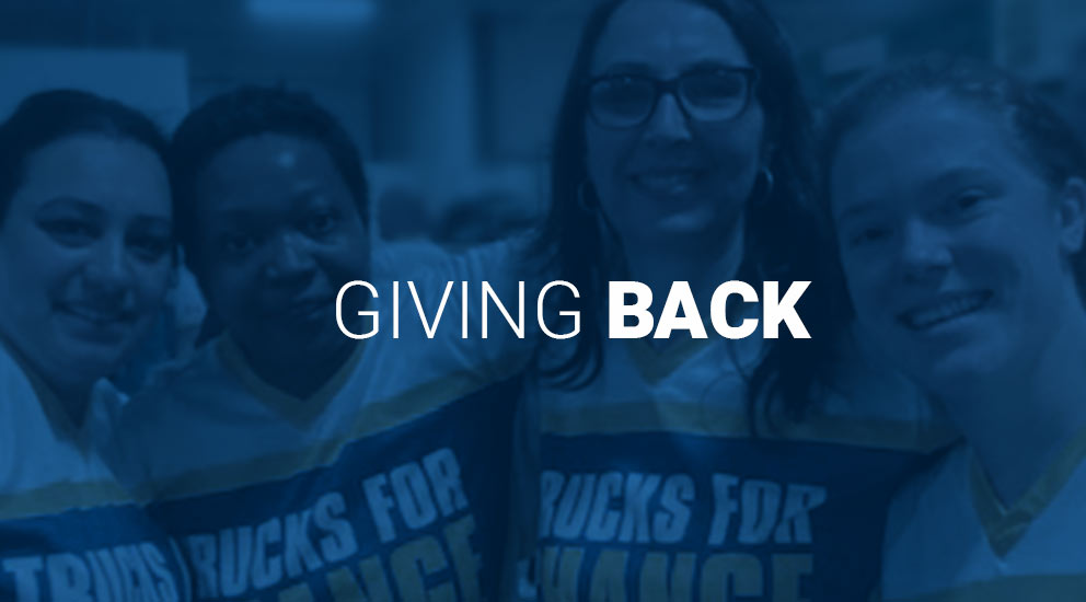Giving Back words with four women wearing Trucks for Change jerseys in background 