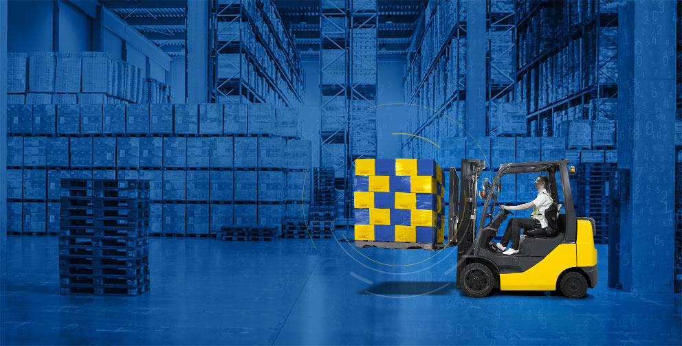 Warehouse interior with yellow forklift holding 20 blue and yellow boxes